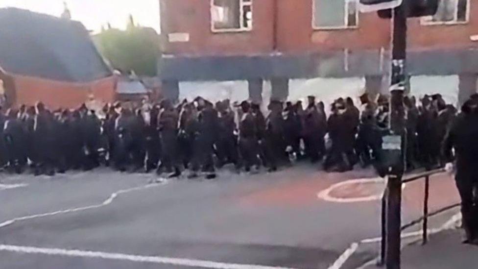 Politicians condemn early morning masked march
