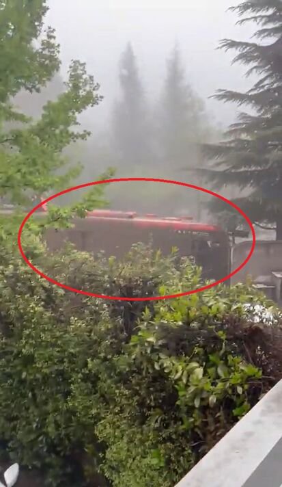 Harrowing moment bus is swept away by mud as terrified passengers cling to roof