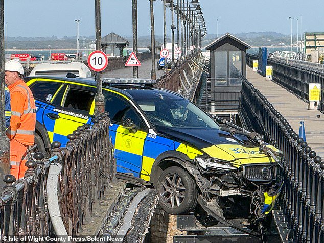Can’t park there, mate! Shocked ferry passengers spot police car dangling from pier