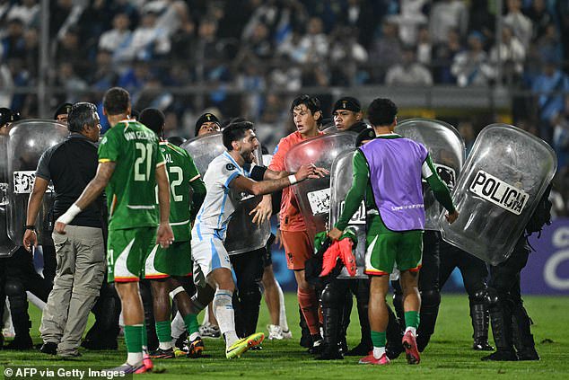 Riot police rush to stop mass brawl after Nations League clash descends into chaos – as Suriname make racism accusation and urge FIFA to take action