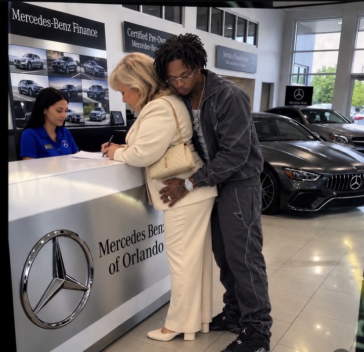 Young Black man hugs older white woman at a Mercedes dealership as people call him a gold digger