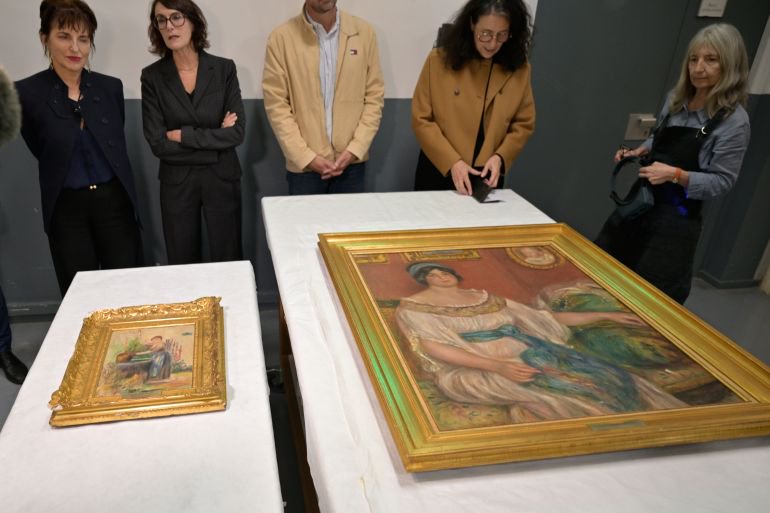 Stolen Renoir paintings found behind wall in France following arrests