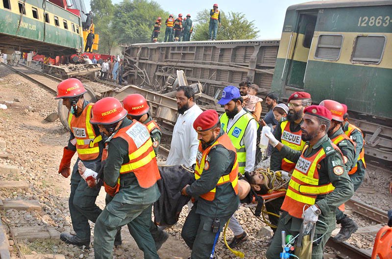 Rescue workers evacuate an injured passenger from a coach after 14 coaches of the Karachi–Peshawar-bound Rehman Baba Express derailed near Sher Shah Railway Station at least four passengers were killed and 49 injured in the incident.