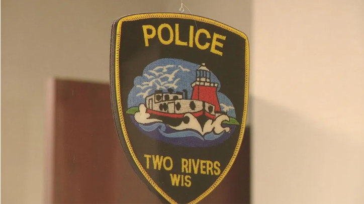 2 in custody in connection with body found in water in Two Rivers