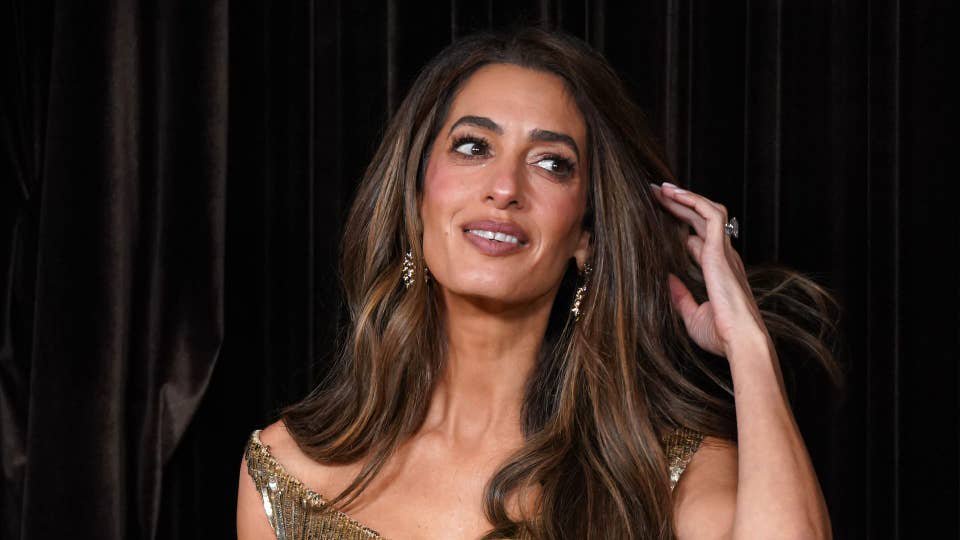 Amal Clooney glitters in gold as she leads the stars at The Albies alongside husband George