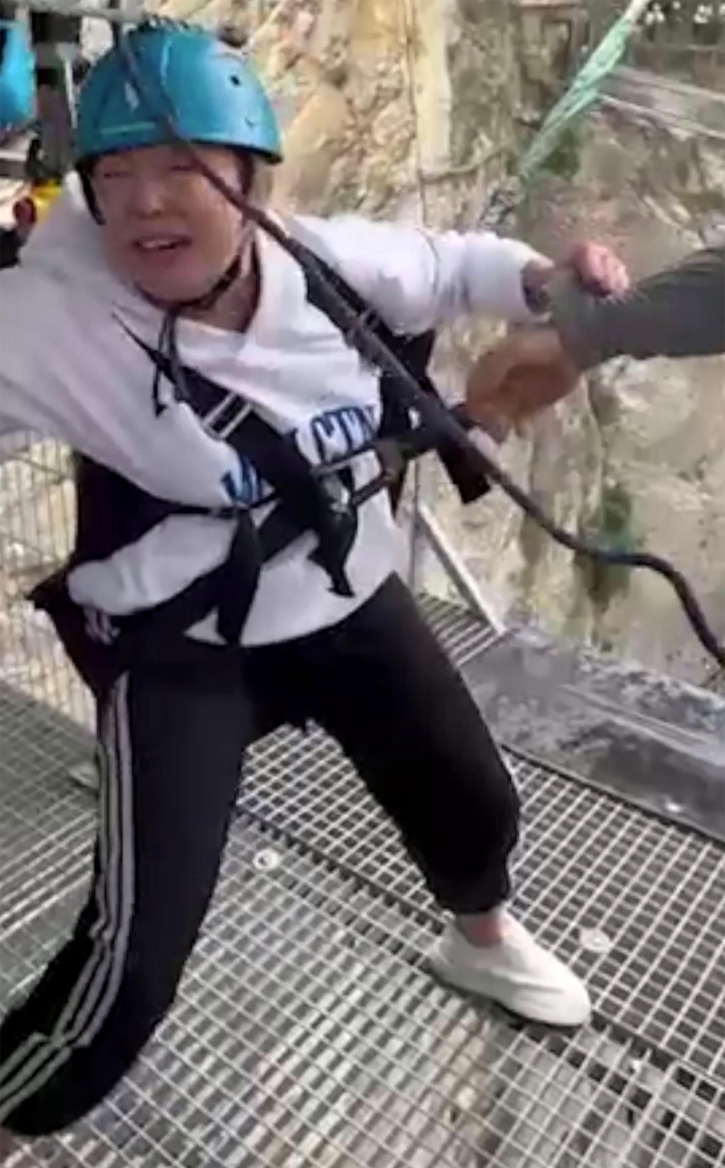 Shocking moment staffers kick terrified woman’s legs away to make her take 260-foot thrill jump