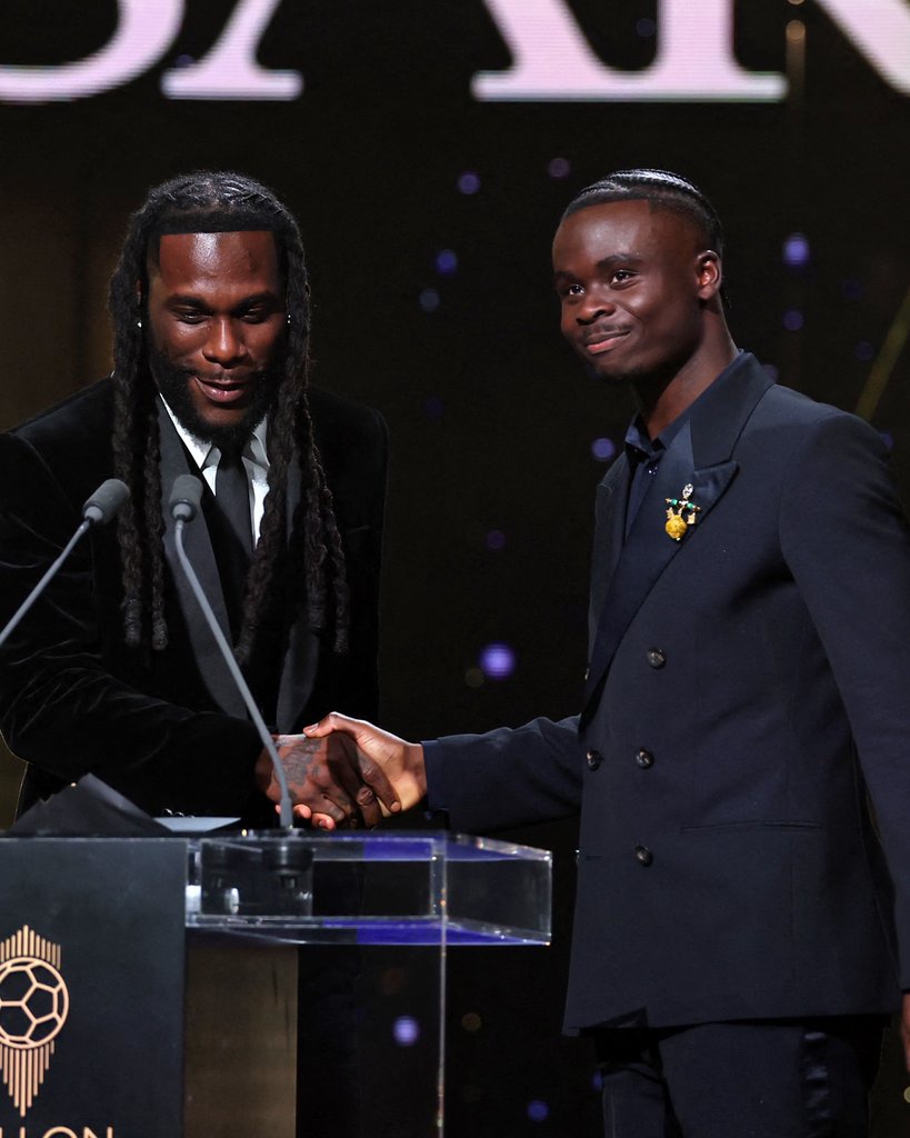 Burna Boy Suits Up to Present Bukayo Saka With the Socrates Award at the 2026 Ballon d’Or