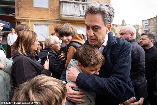 Ed Miliband embraces Ukrainians at scene of Putin bombing raid that killed 22 as Britain announces new sanctions on Russia