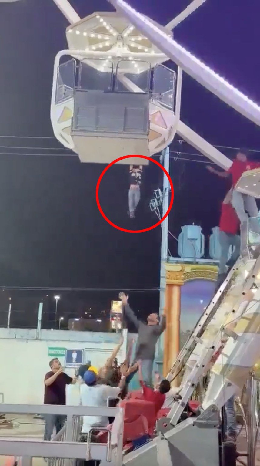 Terrifying moment young boy dangles from Ferris wheel after sneaking away from dad & clinging to gondola