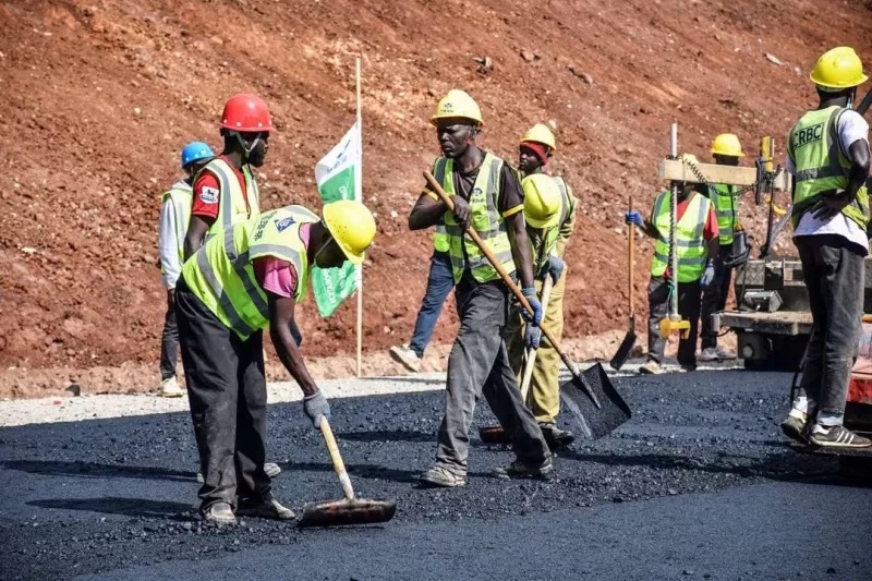 Workers lay tarmac on Rironi-Naivasha Road as deadline nears