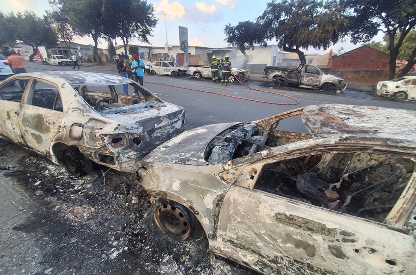 ‘We are tired of foreign nationals’: 24 vehicles torched in Soweto and Durban as protests over asylum ruling erupt into violence