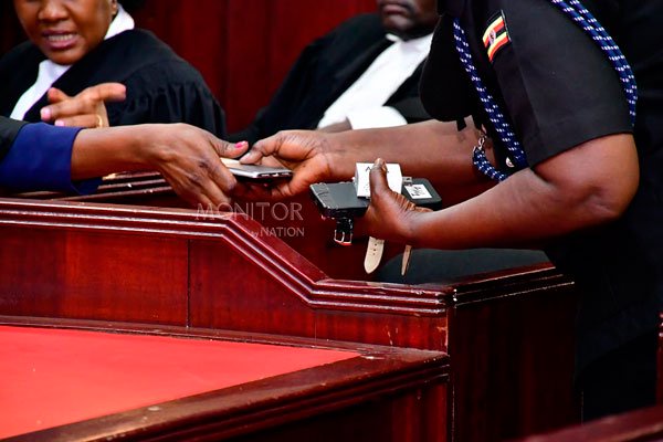 Besigye treason case: Court blocks envelope, flash disk