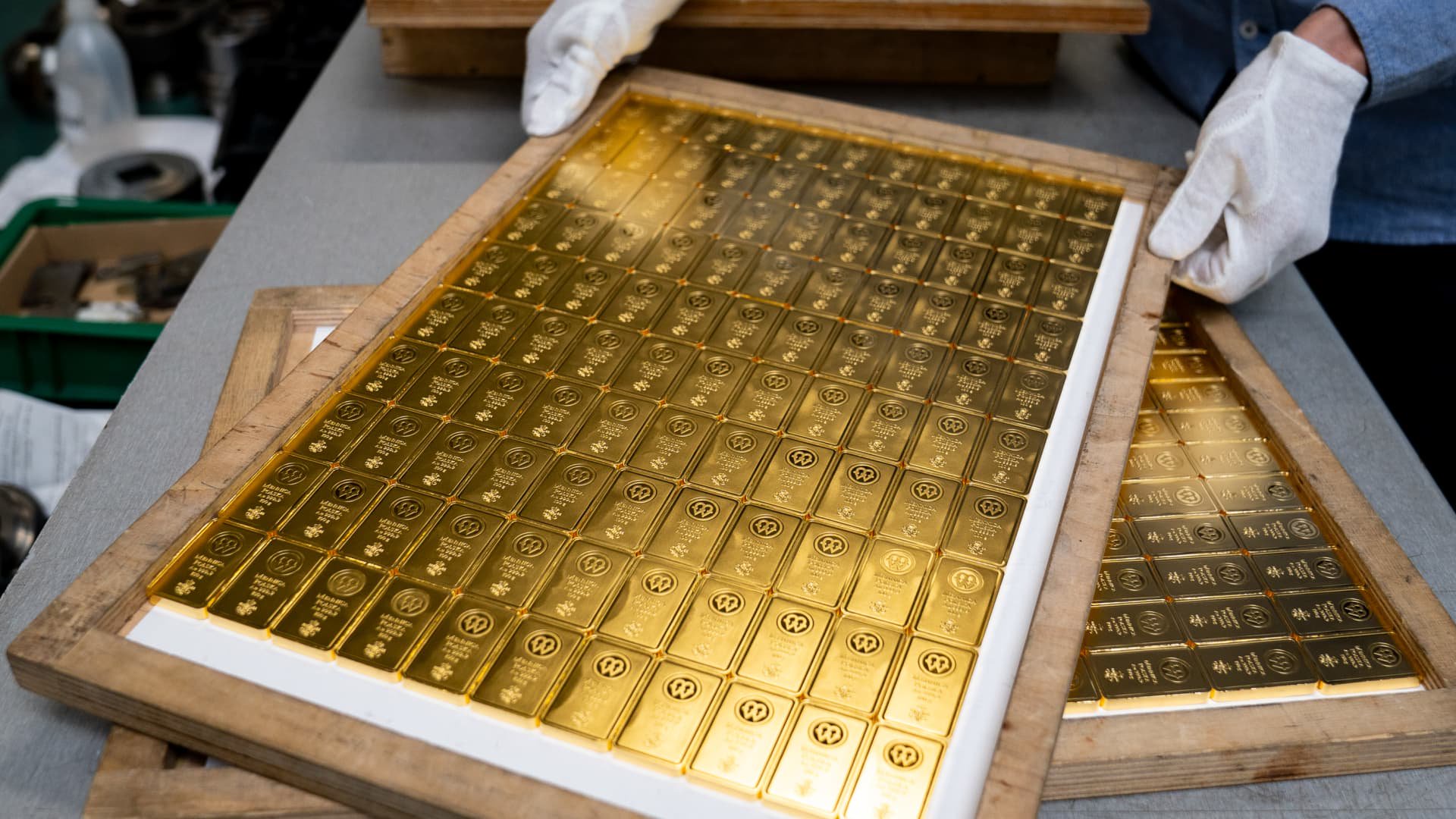 Gold eases on firm dollar; spotlight on U.S. inflation data