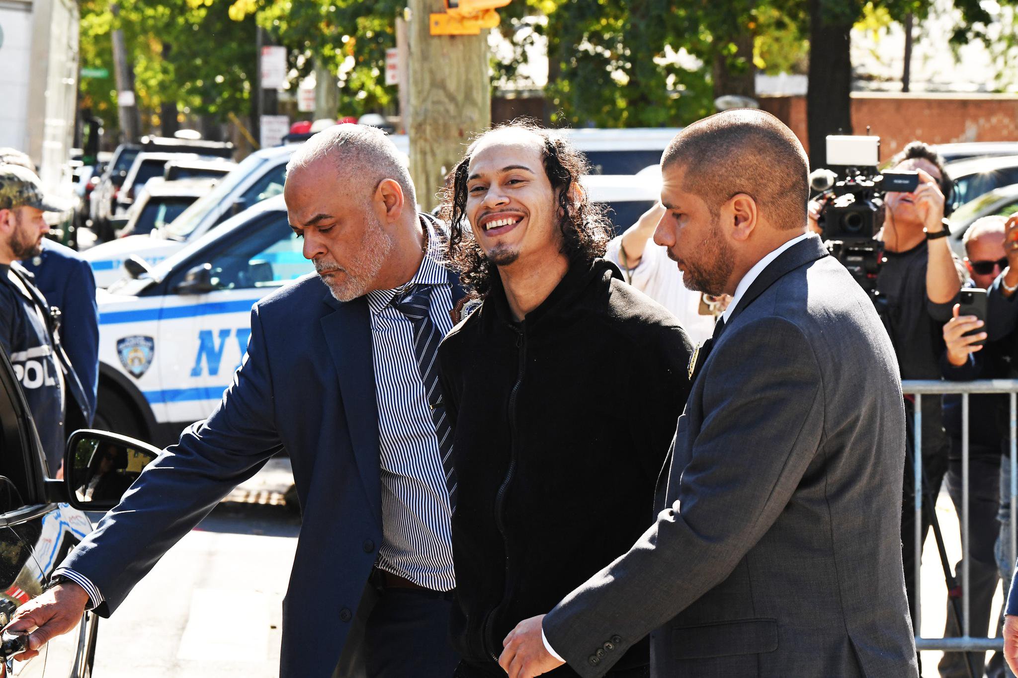 Monster accused of pushing girlfriend, baby off NYC balcony flashes demonic grin as he’s hauled away by cops