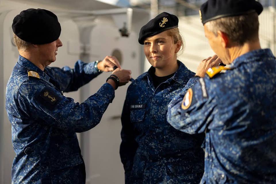 Princess Amalia, 22, is soaked by a bucket of water as she receives special promotion in army uniform