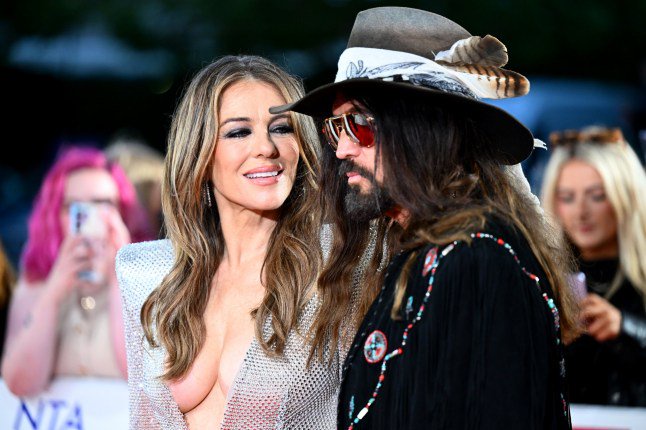 Liz Hurley flashes engagement ring as she gets engaged to Billy Ray Cyrus