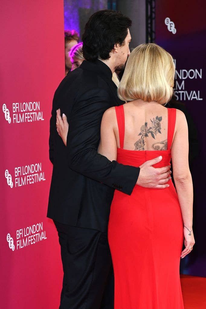 Scarlett Johansson, 41, showcases huge back tattoos in striking red dress at star-studded premiere