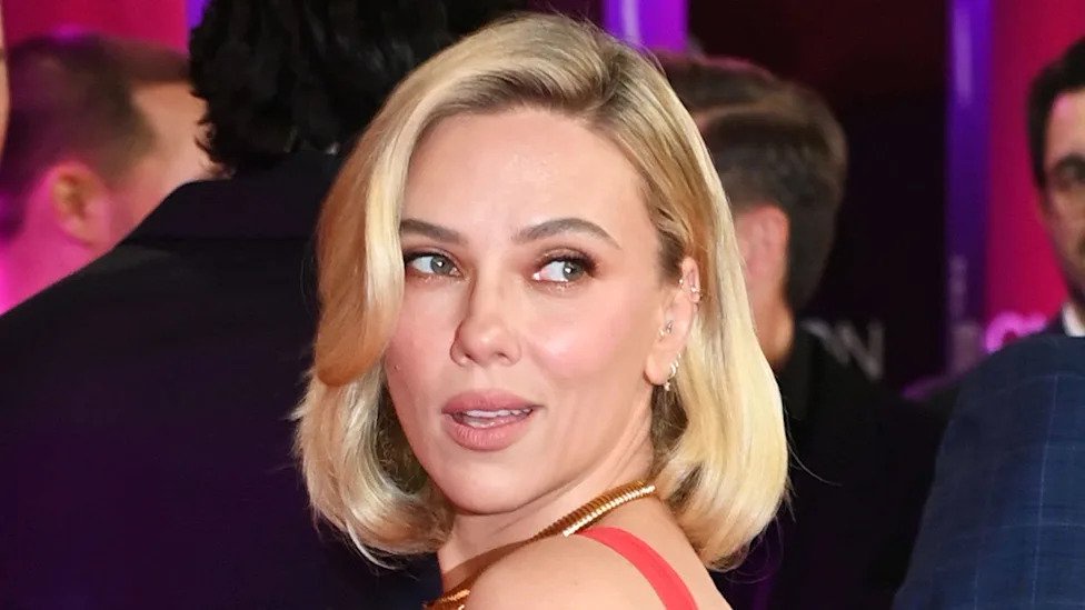 Scarlett Johansson, 41, showcases huge tattoos in stunning red gown