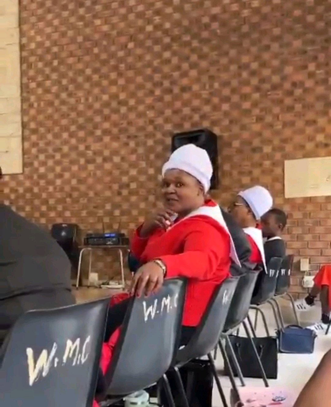Woman filmed using hand gestures to point out men during a church service