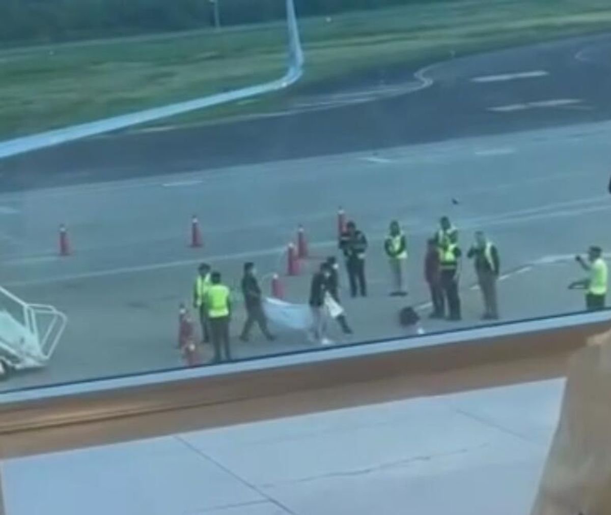 Corpse hauled off plane after passenger dies mid-flight as body spotted being removed