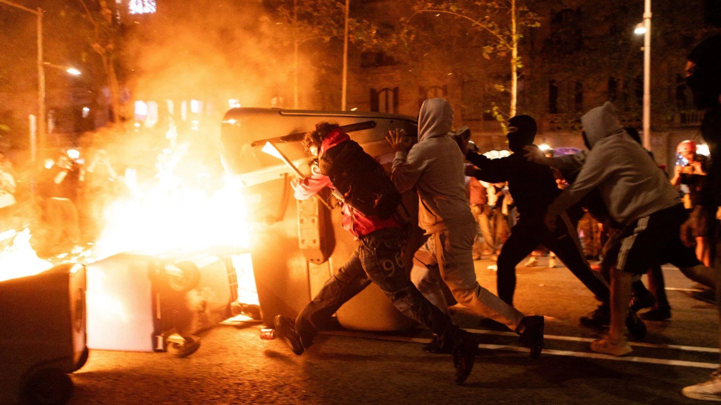 Shocking moment protesters clash with riot cops in Barcelona as masked demonstrators hurl rocks and flares at police