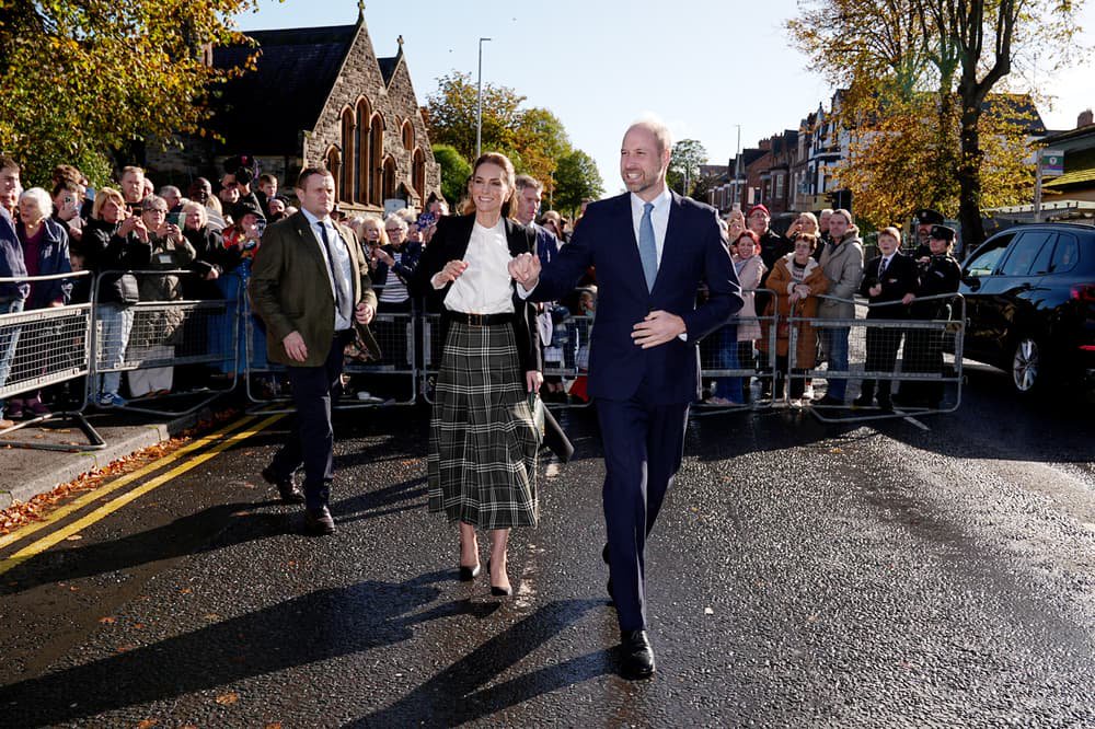 William and Kate dodge rain showers to meet community centre supporters