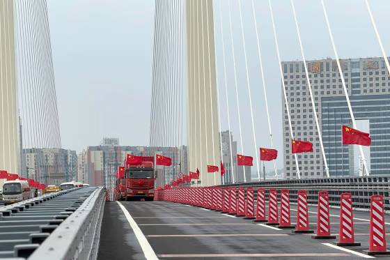 Trucks line up as long-delayed China-North Korea bridge officially opens