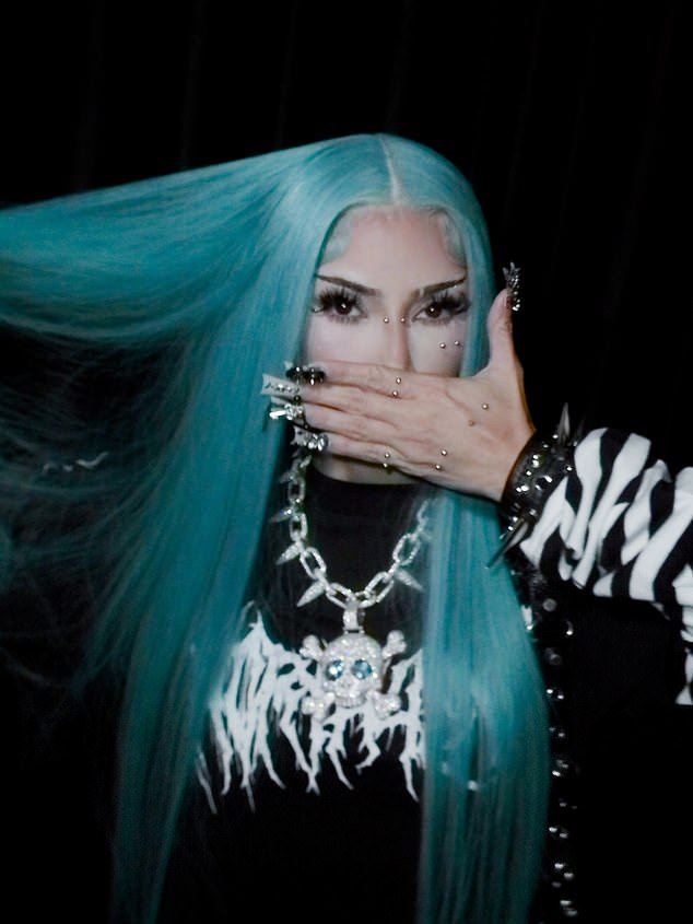 Kim Kardashian transforms into daughter North West for Halloween, complete with blue hair and hand piercings