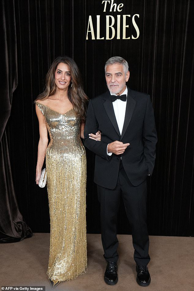 Amal Clooney dazzles in a gold fringed gown as she hosts The Albies star-studded charity event alongside her dapper husband George