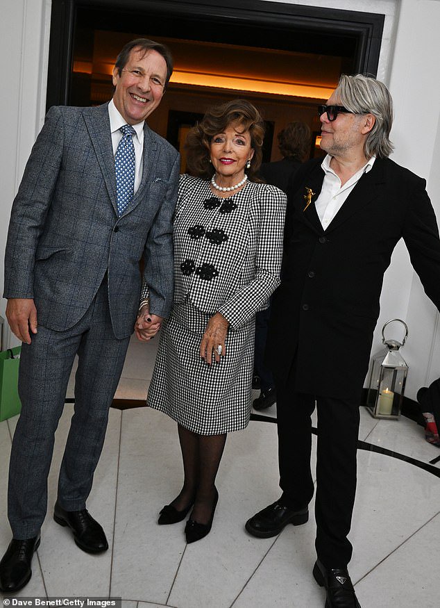 Joan Collins, 93, enjoys a date night with husband Percy Gibson, 61, as they hold hands while attending Claridge’s book launch