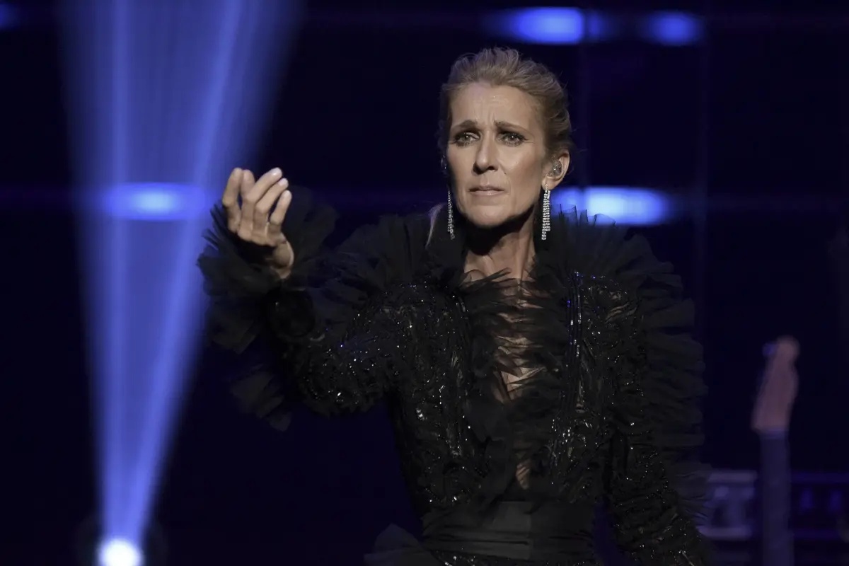 Céline Dion takes a tumble, but goes on