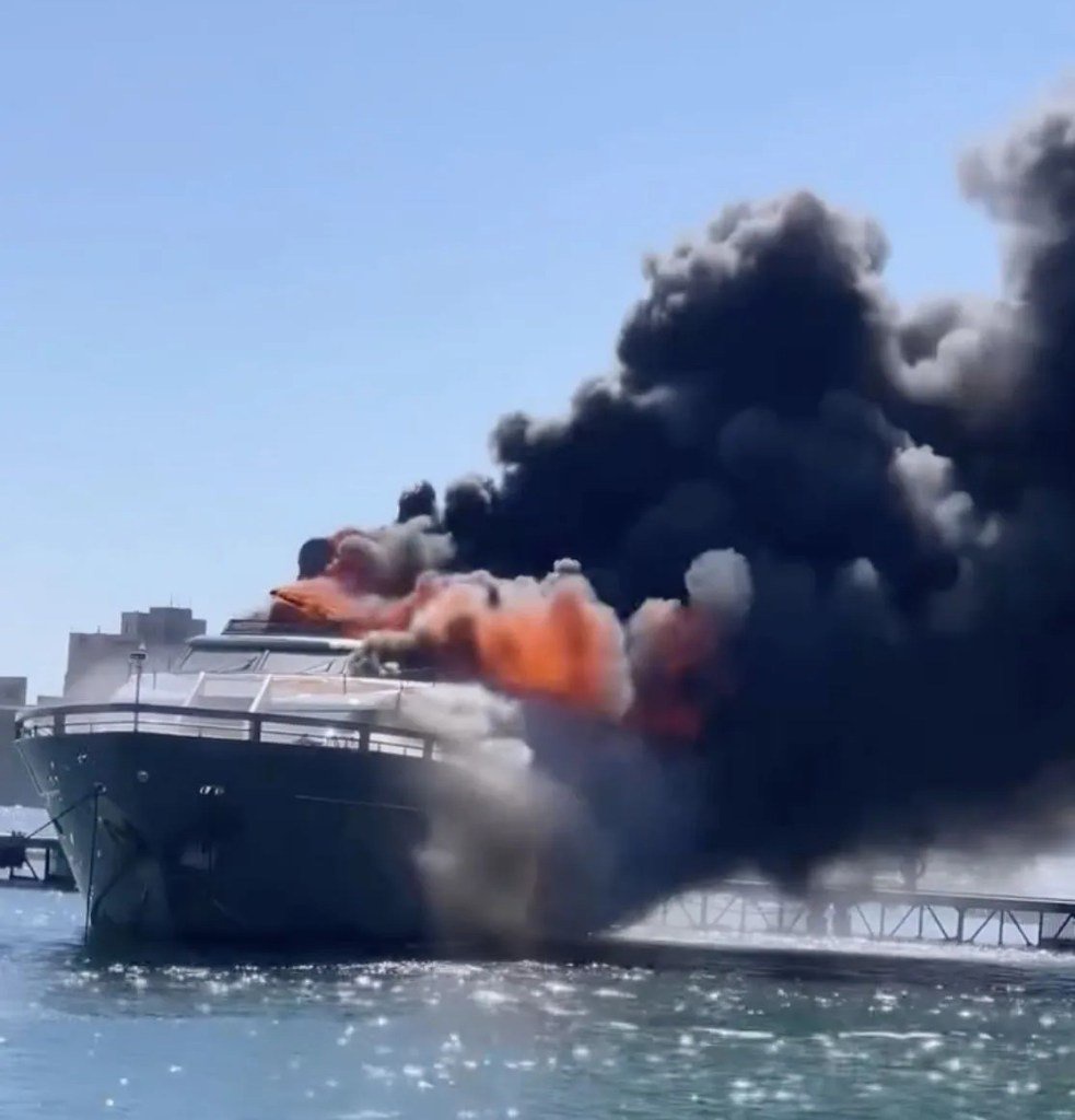 Dramatic moment £6million luxury yacht goes up in flames at Italian marina sending black smoke into sky before sinking