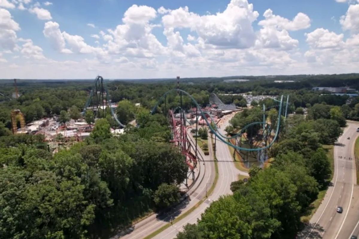 Man dies after fall from giant rollercoaster while son strapped in beside him