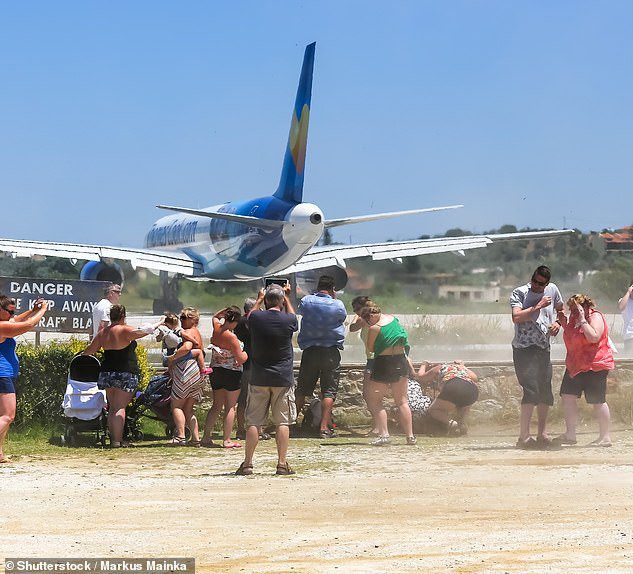 Rise of dangerous ‘jet blast’ trend: Thrill-seeking tourists who stand under ‘intense’ stream of air from plane’s engines warned they risk ‘serious injury’