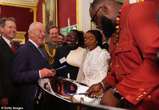 King of music! Charles couldn’t resist playing the steel pans during palace reception